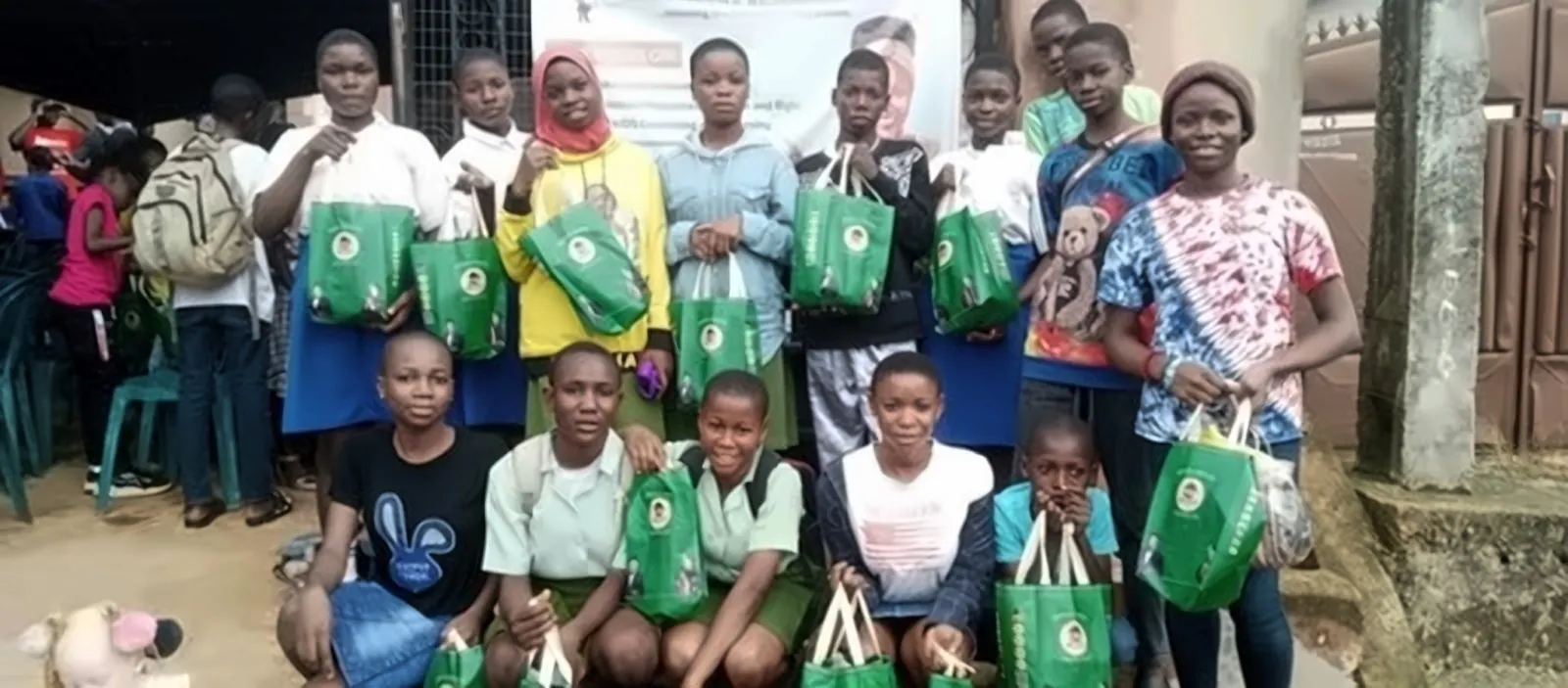 A large group of children holding Edu-Kids gift bags