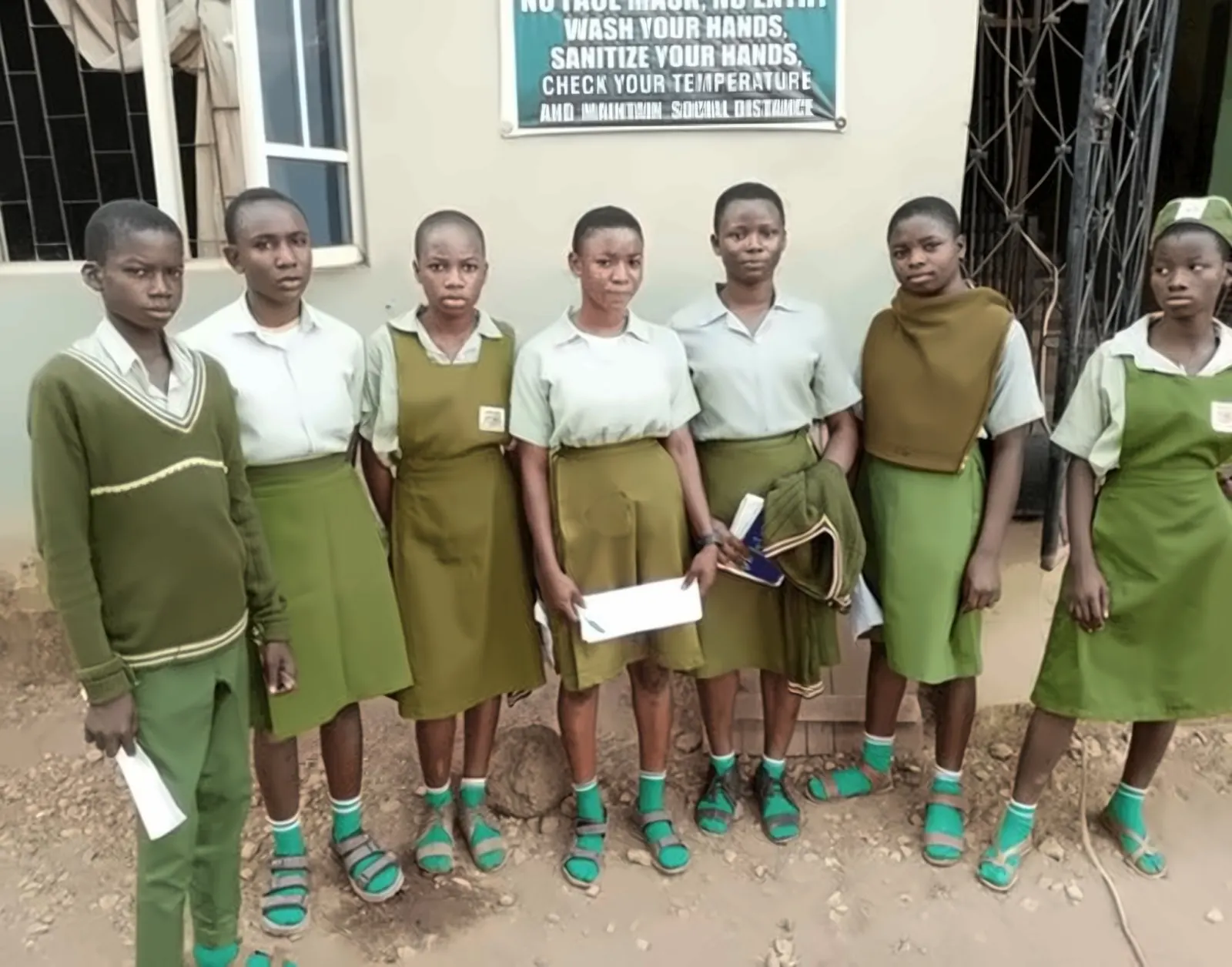 Girls in uniform holding supplies