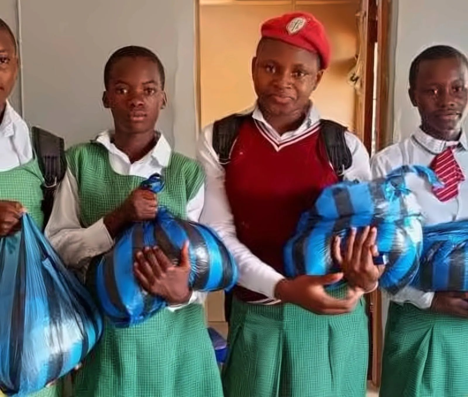 Students holding bags of school supplies