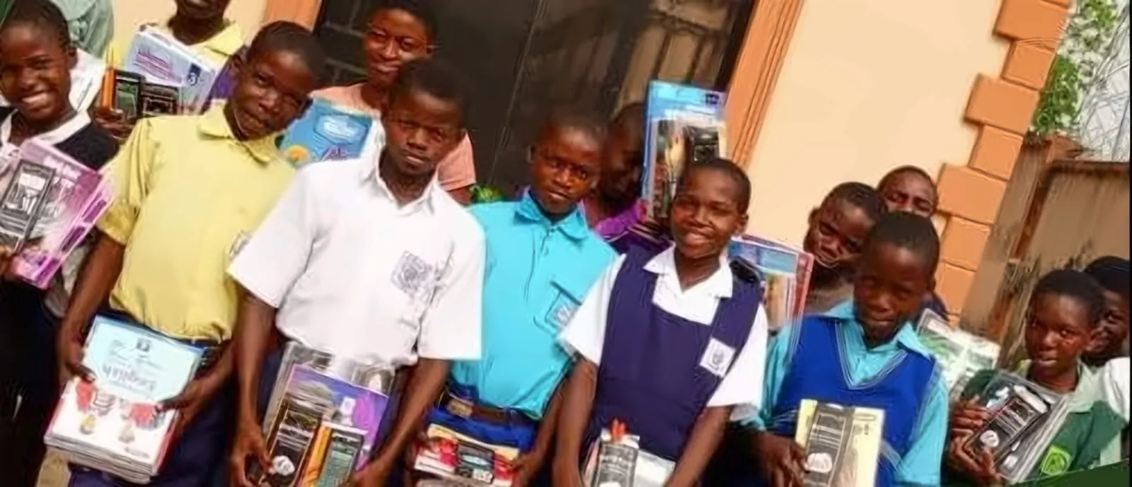Students holding new textbooks and school supplies