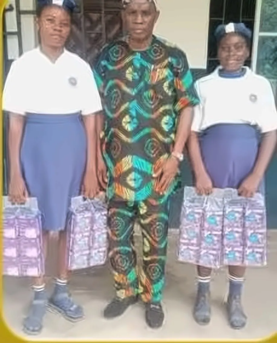 Students receiving sanitary packs with a school official