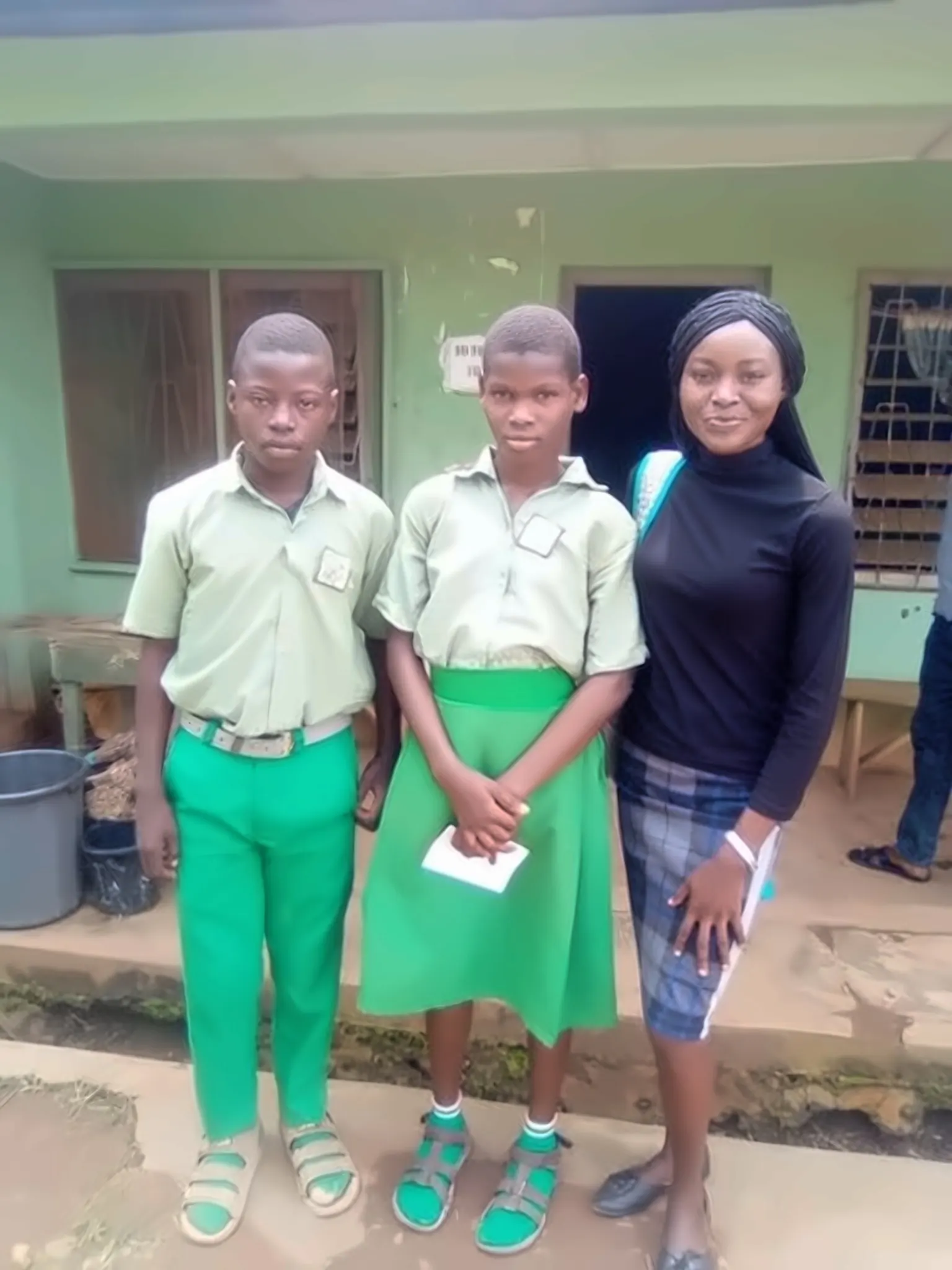 Two students with a volunteer