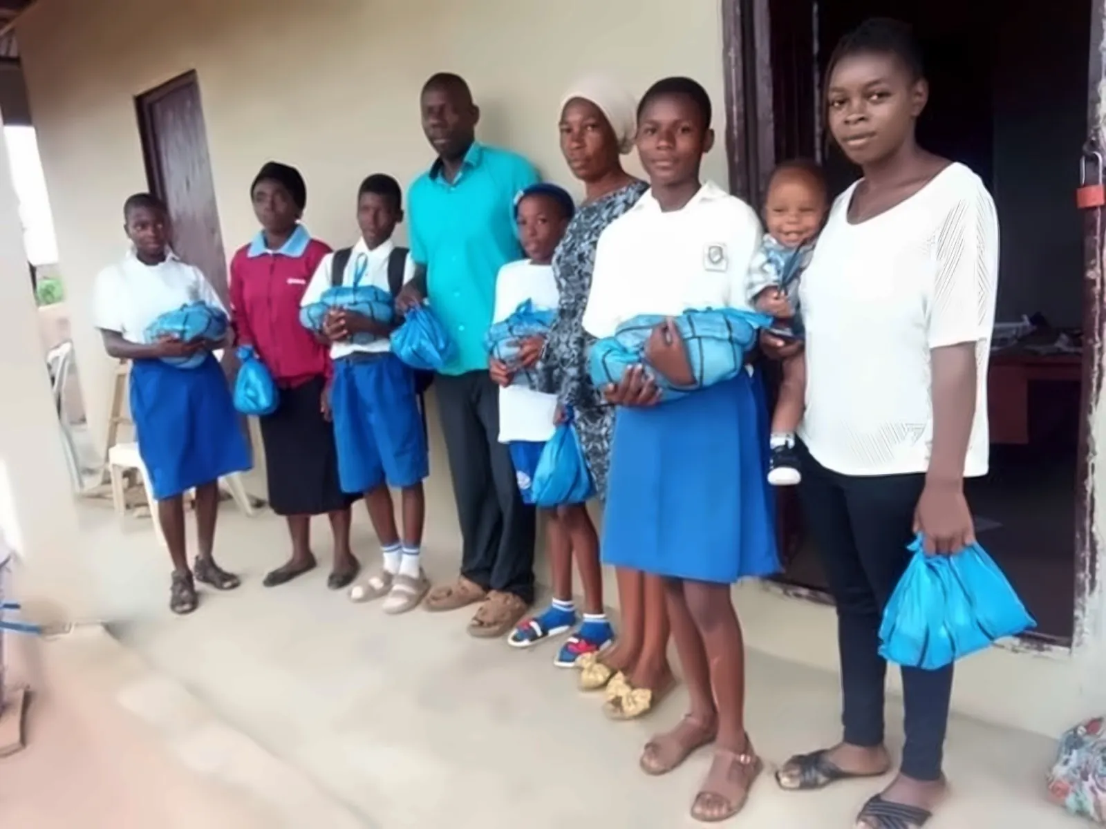 Students and parents receiving bags of supplies
